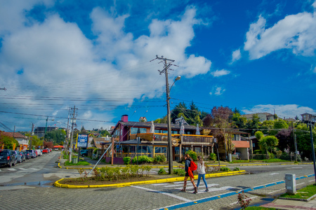 PUERTO VARAS, CHILE, SEPTEMBER, 23, 2018: Unidentified women walking and crossing the streets in Puerto Varas, visiting the city and their colonial placesのeditorial素材