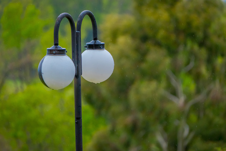 Close up of selective focus of public lamp located at outdoors of the blurred forest landscape in Pucon, Chileの写真素材