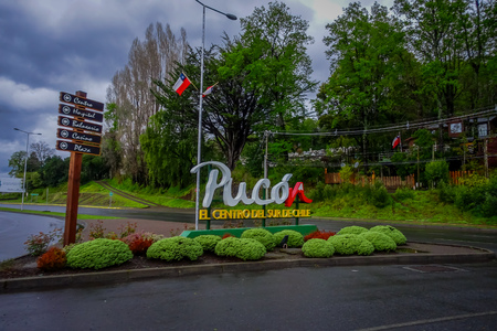 PUCON, CHILE - SEPTEMBER, 23, 2018: Informative wooden signs in a pole with a huge letters at the enter of the town in the city in Puconのeditorial素材