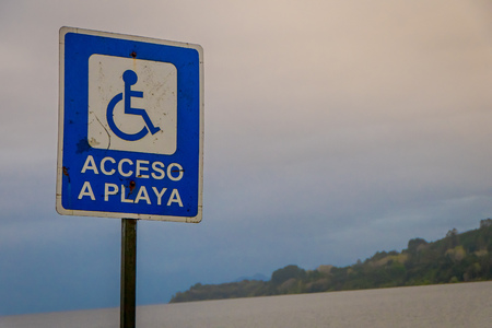 FRUTILLAR, CHILE - SEPTEMBER, 23, 2018: Outdoor view of informative sign of access to the beach for disabled people located in the beach of frutillar in Chileのeditorial素材