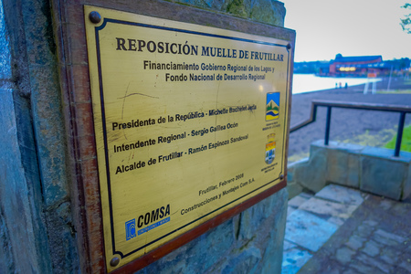 FRUTILLAR, CHILE - SEPTEMBER, 23, 2018: Close up of selective focus of informative sign of wooden pier of Frutillar, southern Chileのeditorial素材