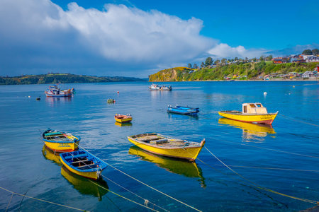 CHILOE, CHILE - SEPTEMBER, 27, 2018: Outdoor view of some boats in a row used for fishermans in the chonchi harbour in Chiloe island Chileのeditorial素材