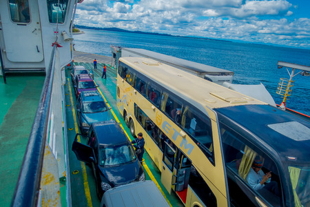 CHILOE, CHILE - SEPTEMBER, 27, 2018: Above view of cars inside of ferry and passengers for crossing from the Chilean mainland to the Island of Chiloeのeditorial素材