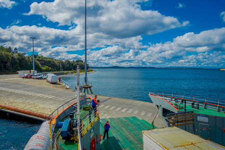 CHILOE, CHILE - SEPTEMBER, 27, 2018: Above view of cars inside of ferry and passengers for crossing from the Chilean mainland to the Island of Chiloeのeditorial素材