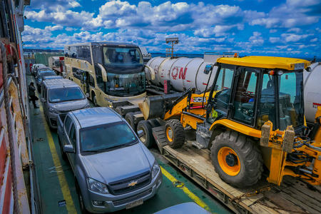CHILOE, CHILE - SEPTEMBER, 27, 2018: Above view of cars inside of ferry and passengers for crossing from the Chilean mainland to the Island of Chiloeのeditorial素材