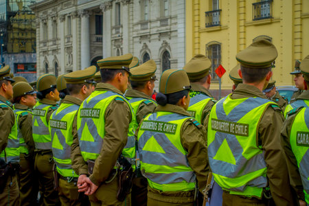 SANTIAGO, CHILE - SEPTEMBER 13, 2018: Back view of Police called as carabineros checking the crowd...