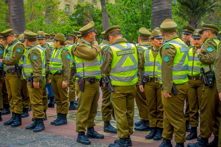 SANTIAGO, CHILE - SEPTEMBER 13, 2018: Outdoor view of crowd of Police called as carabineros in the line ready to check the crowd for segurity in Santiagoのeditorial素材