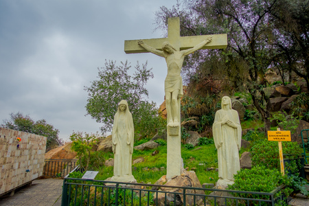 SANTIAGO, CHILE - OCTOBER 16, 2018: Outdoor view of stoned cross with a Jesus, sith stow stoned sculptures next to the cross, located in the top of the San Cristobal Hillのeditorial素材