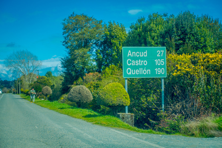 CHILOE, CHILE - SEPTEMBER, 27, 2018: Outdoor view of informative sign of distance for commming cities from the sign point in Chacao in Chileのeditorial素材