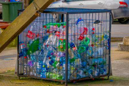 CHILOE, CHILE - SEPTEMBER, 27, 2018: Outdoor view of metallic box with some plastic botlles inside, recycling concept, ecological friendly city located on Lemuy Islandのeditorial素材