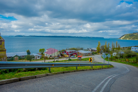 CHILOE, CHILE - SEPTEMBER, 27, 2018: Outdoor beautiful view of wooden house buildings in the pier with huge lake in front located at Chiloe island, south of Chileのeditorial素材