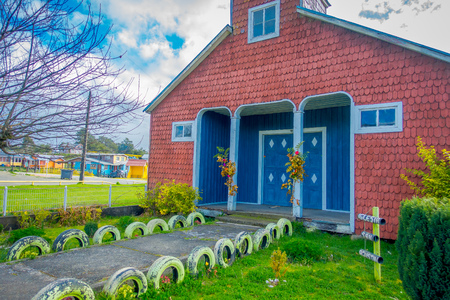CHILOE, CHILE - SEPTEMBER, 27, 2018: Outdoor view of backyard with stoned path of quinchao church, one of world heritage wooden churches located at Chiloe islandのeditorial素材