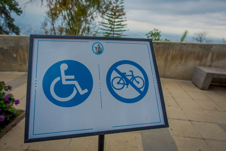 SANTIAGO, CHILE - OCTOBER 16, 2018: Informative sign of people in chair wheel and do not allow bikes at Cerro San Cristobal in Santiago de Chile, Chileのeditorial素材