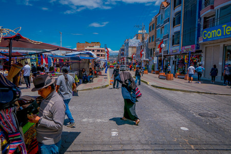 OTAVALO, ECUADOR, NOVEMBER 06, 2018: Outdoor view of vendors and visitors attending the weekly market on the street of the popular indigenous townのeditorial素材
