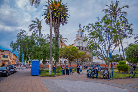 OTAVALO, ECUADOR, NOVEMBER 06, 2018: Unidentified people walking in front of Matriz Church in Calderon Park, Cotacachiのeditorial素材