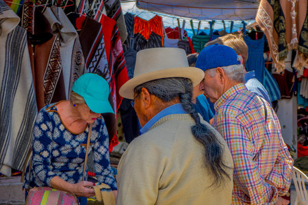 OTAVALO, ECUADOR, NOVEMBER 06, 2018: Tourists buying handycrafts in a street market located in the city of Otavaloのeditorial素材
