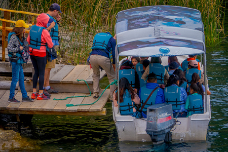 CUICOCHA, ECUADOR, NOVEMBER 06, 2018: Tourists boarding a boat to have a tour in the Cuicocha lake in Ecuadorのeditorial素材
