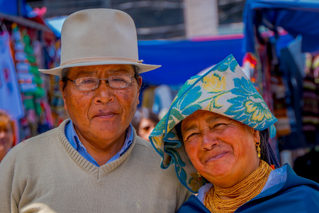 OTAVALO, ECUADOR, NOVEMBER 06, 2018: Portrait of indigenous couple posing for camera and wearing andean traditional clothing in street market in Otavaloのeditorial素材