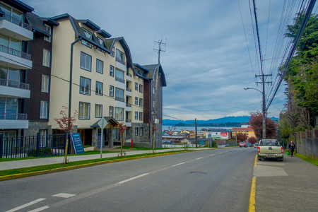 PUERTO VARAS, CHILE, SEPTEMBER, 23, 2018: Outdoor view of some cars parked at one side of the street with volcano Osorno background located in Puerto Varas in Chileのeditorial素材