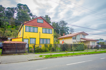 PUERTO VARAS, CHILE, SEPTEMBER, 23, 2018: Outdoor view of yellow wooden house building located in Puerto Varas in Chileのeditorial素材