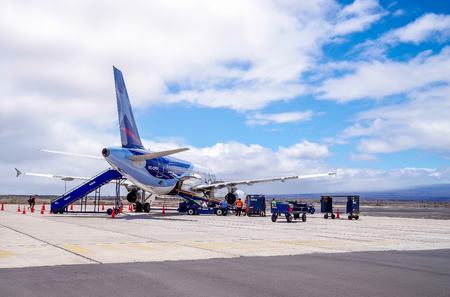 GALAPAGOS, ECUADOR, NOVEMBER, 25 2018: Tourists walking towards and boarding a Lan airplane on Galapagos airport Ecuadorのeditorial素材