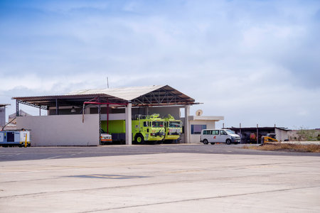 BALTRA, GALAPAGOS - NOVEMBER 25, 2018: Outdoor view of cars under a metallic structure located in...