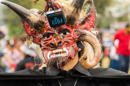 Quito, Ecuador - September, 03, 2018: Close up of unidentified man dressed up and participating in the Diablada, popular town celebrations with people dressed as devils dancing in the streetsのeditorial素材