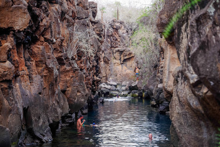Puerto Ayora, Galapagos, Ecuador - November 25, 2018: Tourists swimming in Las Grietas on Santa Cruz Island in Galapagos. It is popular tourist destinationのeditorial素材