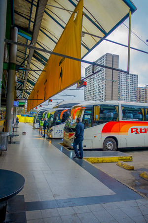 SANTIAGO, CHILE - OCTOBER 09, 2018: Outdoor view of buses parked in a row inside of the terminal at the platforms at Alameda station. This is the largest and primary bus terminal of the cityのeditorial素材