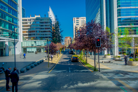 SANTIAGO, CHILE - OCTOBER 16, 2018: Unidentified people walking in the streets of gorgeous financial center buildings district in Las Condes with some plants in the sidewalkのeditorial素材