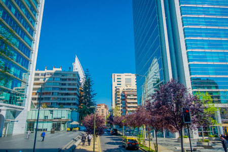 SANTIAGO, CHILE - OCTOBER 16, 2018: Unidentified people walking in the streets of gorgeous financial center buildings district in Las Condes with some plants in the sidewalkのeditorial素材