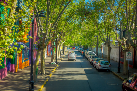 SANTIAGO, CHILE - SEPTEMBER 13, 2018: Outdoor view of cars parked at one side of the street in Santiago of Chile, close to some green treesのeditorial素材