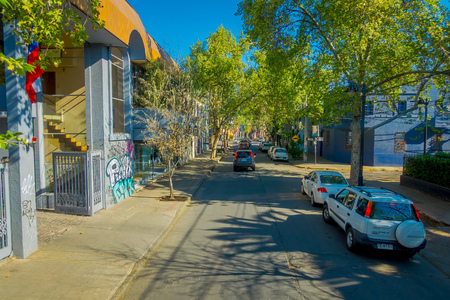 SANTIAGO, CHILE - SEPTEMBER 13, 2018: Outdoor view of cars parked at one side of the street in Santiago of Chile, close to some green treesのeditorial素材