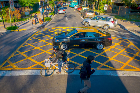 SANTIAGO DE CHILE, CHILE - OCTOBER 16, 2018: Above view of people using the zebra cross with traffic on the streets of the city in Santiago de Chileのeditorial素材