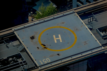 SANTIAGO, CHILE - SEPTEMBER 13, 2018: Outdoor blurred heliport located in the top of a huge building with a gorgeous cityscape of Santiago de Chile.のeditorial素材