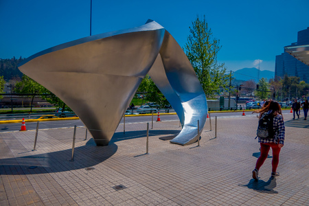 SANTIAGO, CHILE - SEPTEMBER 13, 2018: Outdoor view of unidentified women walking in the sidewalk close to abstract metallic architecture in the street of Santiago de Chileのeditorial素材