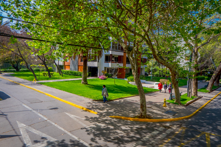 SANTIAGO, CHILE - SEPTEMBER 13, 2018: Outdoor view of cars parked at one side of the street under an ecological street surrounded of plants during gorgeous beautiful sunny day at Santiagoのeditorial素材