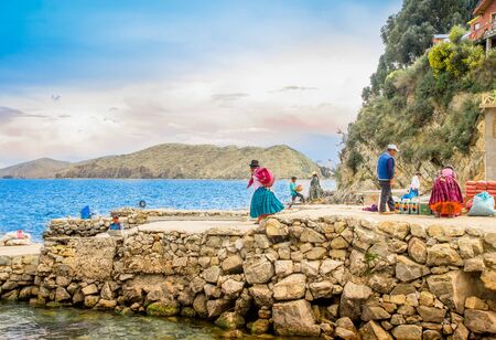 ISLA DEL SOL, BOLIVIA - MAY 12, 2018: Locals build a stone pier in Challa village on Isla del Sol Island of the Sun in. Titicaca lake, Boliviaのeditorial素材