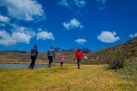 Cotopaxi, ECUADOR - 08 September 2019: Unidentified individuals walking on the Shore of the lake...