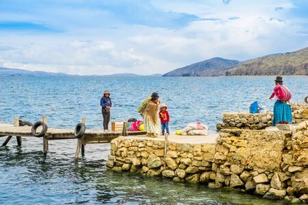 ISLA DEL SOL, BOLIVIA - MAY 12, 2018: Locals build a stone pier in Challa village on Isla del Sol Island of the Sun in. Titicaca lake, Bolivia.のeditorial素材