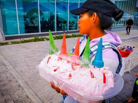 Quito, ECUADOR, 25 October 2019: Woman Street Vendor at Center of Quito, ice cream and snacksのeditorial素材