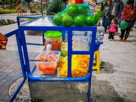 Quito, ECUADOR, 25 October 2019: Woman Street Vendor at Center of Quito, ice cream and snacksのeditorial素材