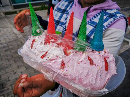 Quito, ECUADOR, 25 October 2019: Woman Street Vendor at Center of Quito, ice cream and snacksのeditorial素材