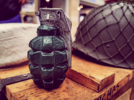Close up view of hand grenade on boxes of army supplies.