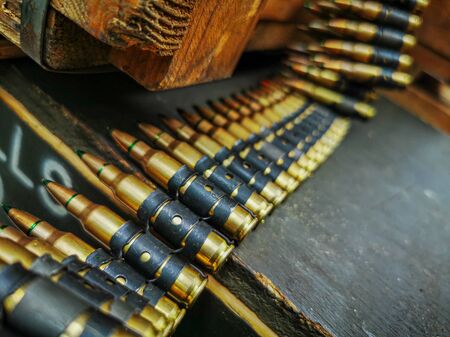 A macro close up view of a row of regular army brass and copper bullets.の写真素材