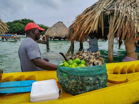 BARU, CARTAGENA, COLOMBIA - NOVEMBER 09, 2019 : Ocean bar in Cholon beach. Tropical hut seats inside turquoise blue sea at the beachのeditorial素材