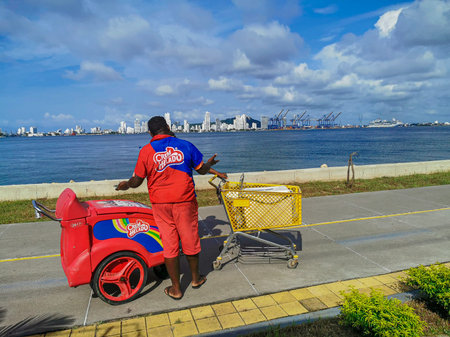 CARTAGENA, COLOMBIA - NOVEMBER 12, 2019: Street vendors by the beach outside the colorful historic city centre.のeditorial素材