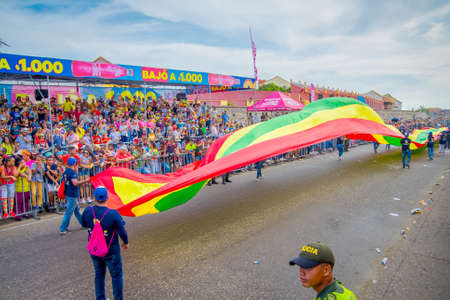 CARTAGENA, COLOMBIA - NOVEMBER 07, 2019: Unidentified people parading with a city flag in the independece day parade on the streets of Cartagenaのeditorial素材