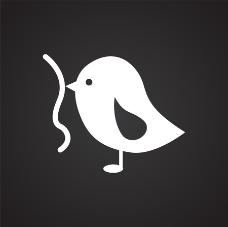 Bird with worm on black background iconの写真素材