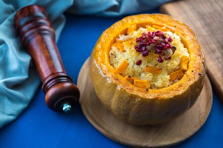 Baked Pumpkin with Rice and spices. Cut Baked Pumpkin with Rice and pomegranate with onionの写真素材